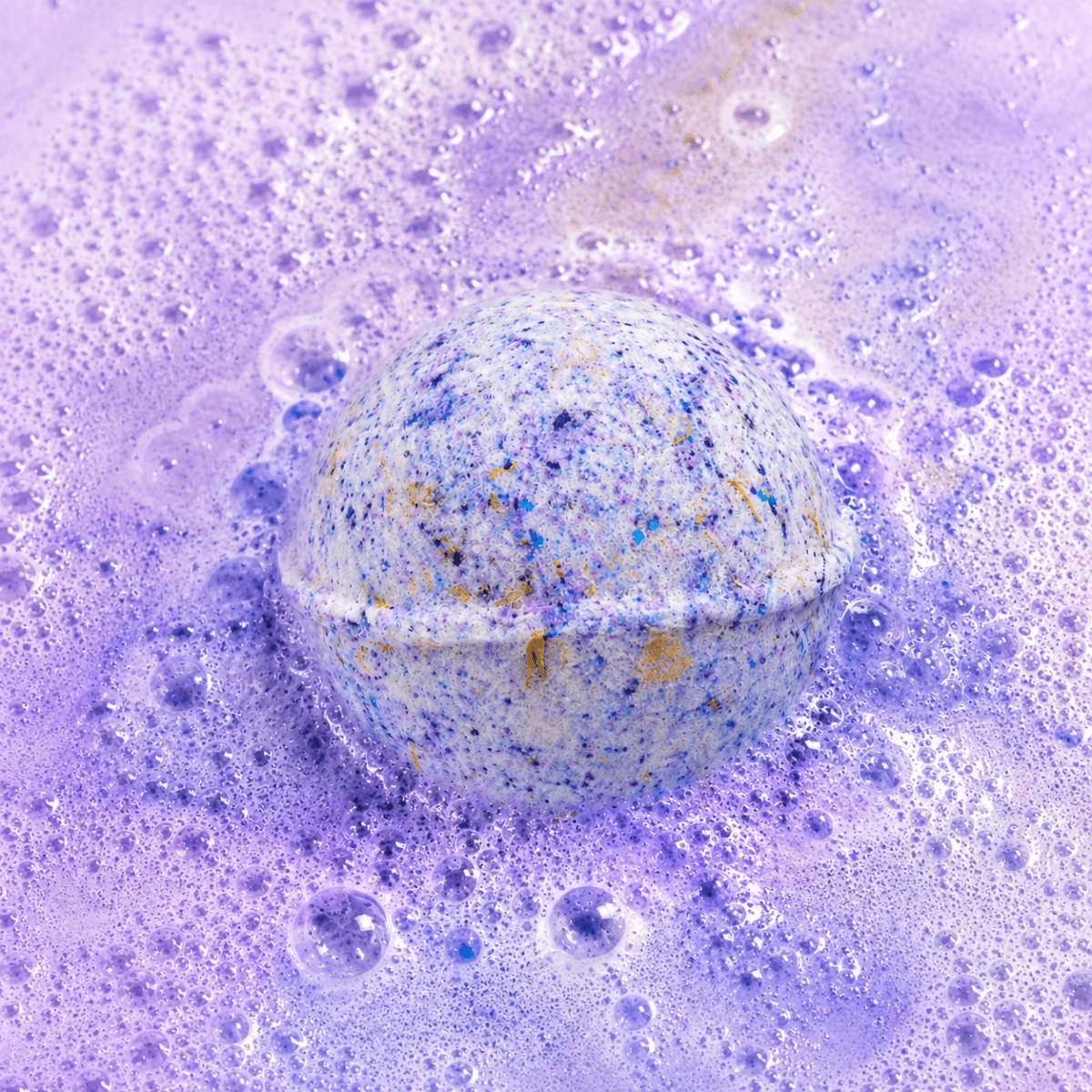 Bedtime Brew Black Tea & Lychee Bath Bomb fizzing in water by Bath Box