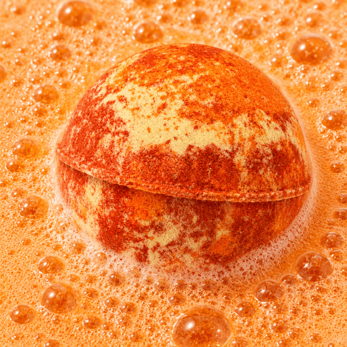 Recharge Musk & Myrrh Bath Bomb fizzing in water by Bath Box