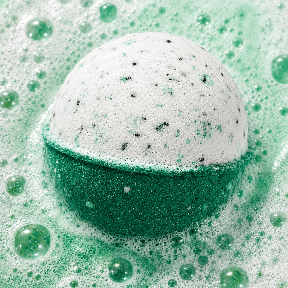 Recovery Mode Eucalyptus Bath Bomb fizzing in water by Bath Box