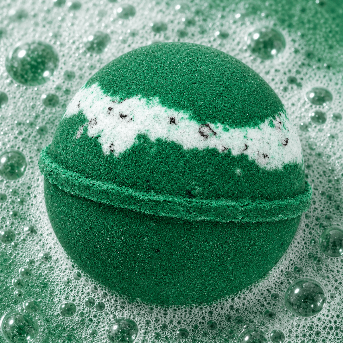Sunday Reset Green Tea Bath Bomb fizzing in water by Bath Box
