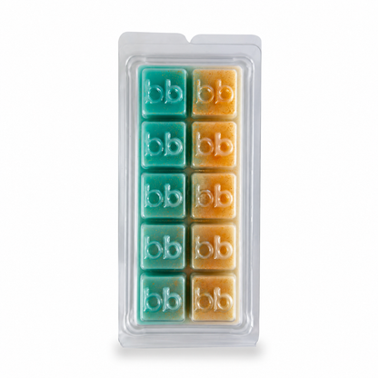 Tis the Season vanilla bourbon soy wax melts in a clear clamshell pack, teal and ivory cubes embossed with the Bath Box logo