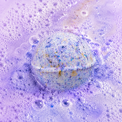 Bedtime Brew Black Tea & Lychee Bath Bomb fizzing in water by Bath Box