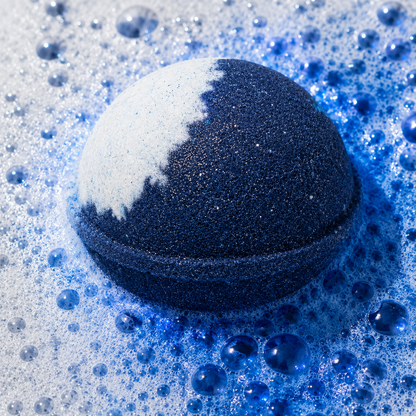 Moonlight Sandalwood Vanilla Bath Bomb fizzing in water by Bath Box