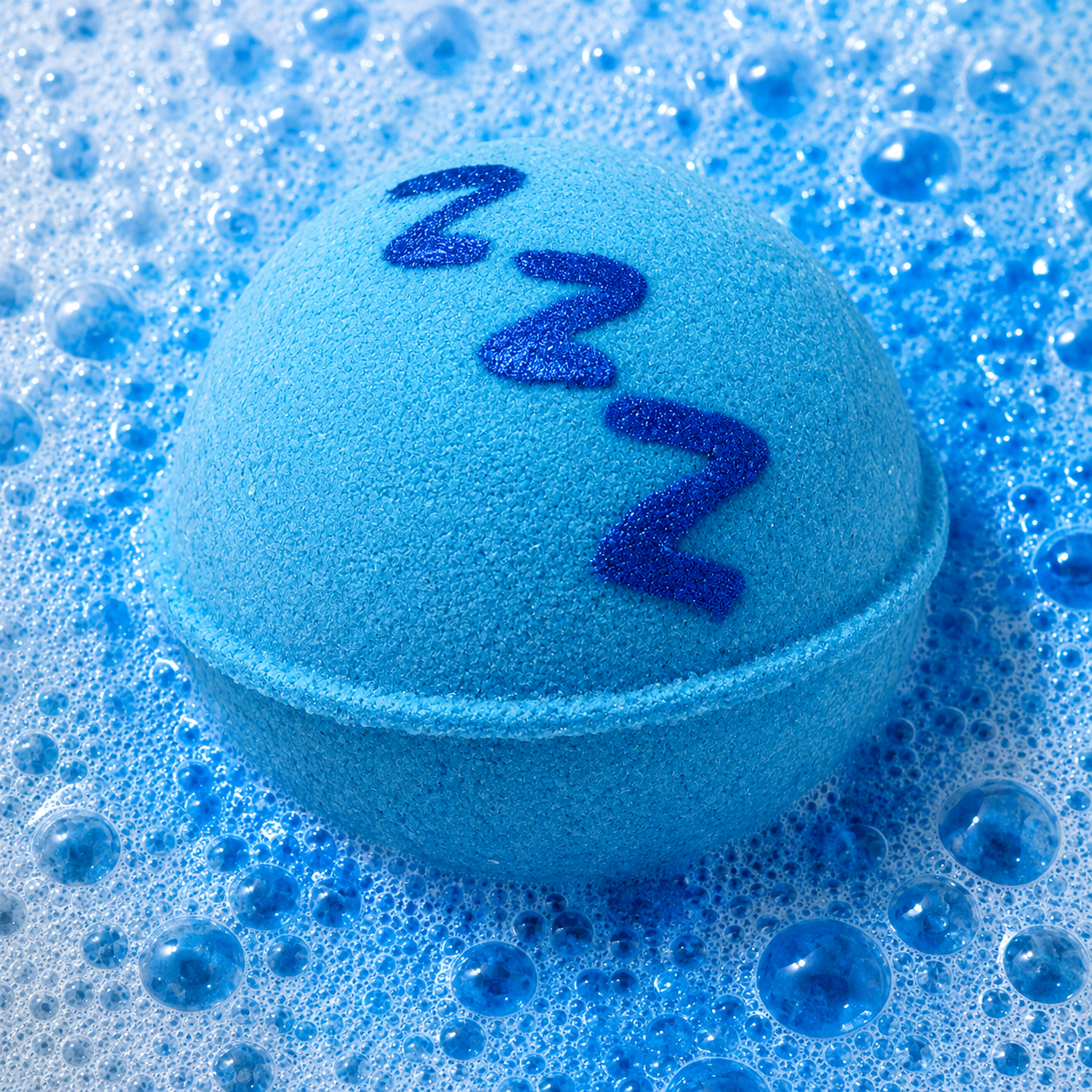 Pillow Talk Pure Musk Bath Bomb fizzing in water by Bath Box