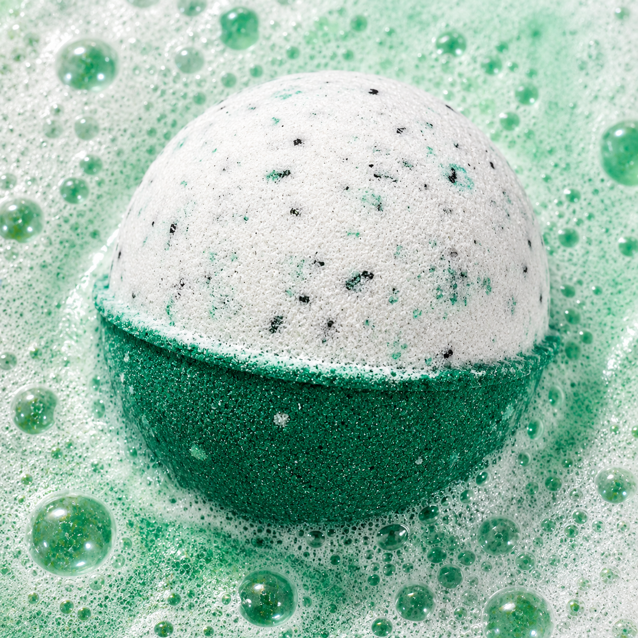 Recovery Mode Eucalyptus Bath Bomb fizzing in water by Bath Box