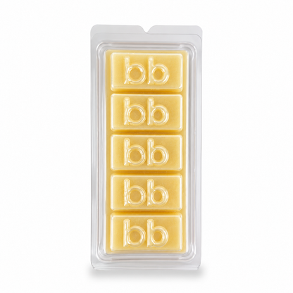 White Christmas sugar cookie soy wax melts in a clear clamshell pack, creamy ivory cubes embossed with the Bath Box logo