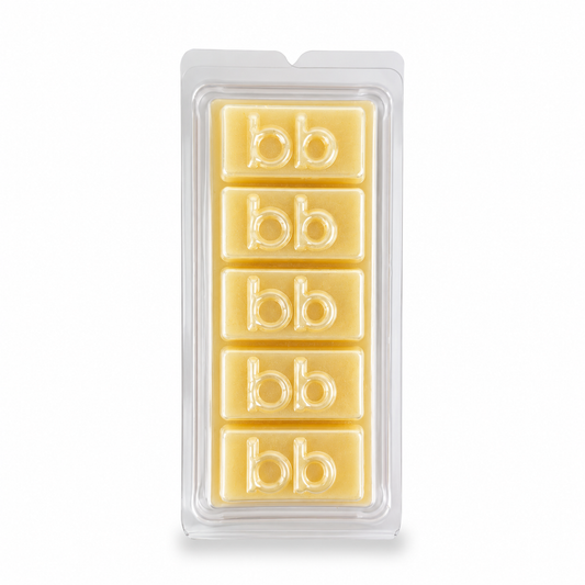 White Christmas sugar cookie soy wax melts in a clear clamshell pack, creamy ivory cubes embossed with the Bath Box logo