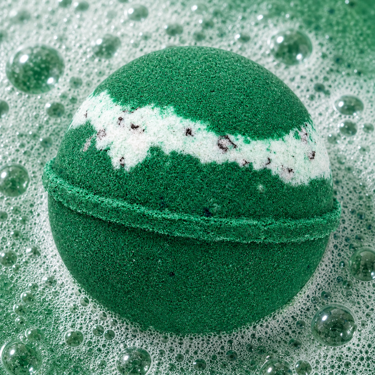 Sunday Reset Green Tea Bath Bomb fizzing in water by Bath Box
