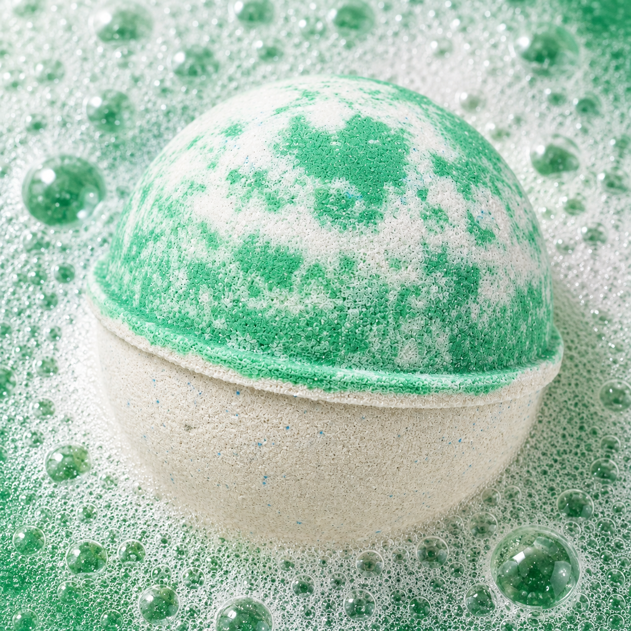 Zen Garden Vanilla Bourbon Bath Bomb fizzing in water by Bath Box